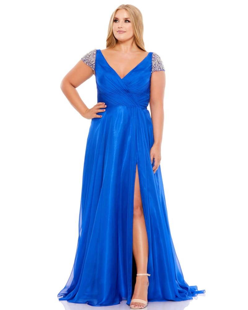 Front of a model wearing a size 14W Beaded Cap Sleeve Faux Wrap Gown in Cobalt by Mac Duggal. | dia_product_style_image_id:289947